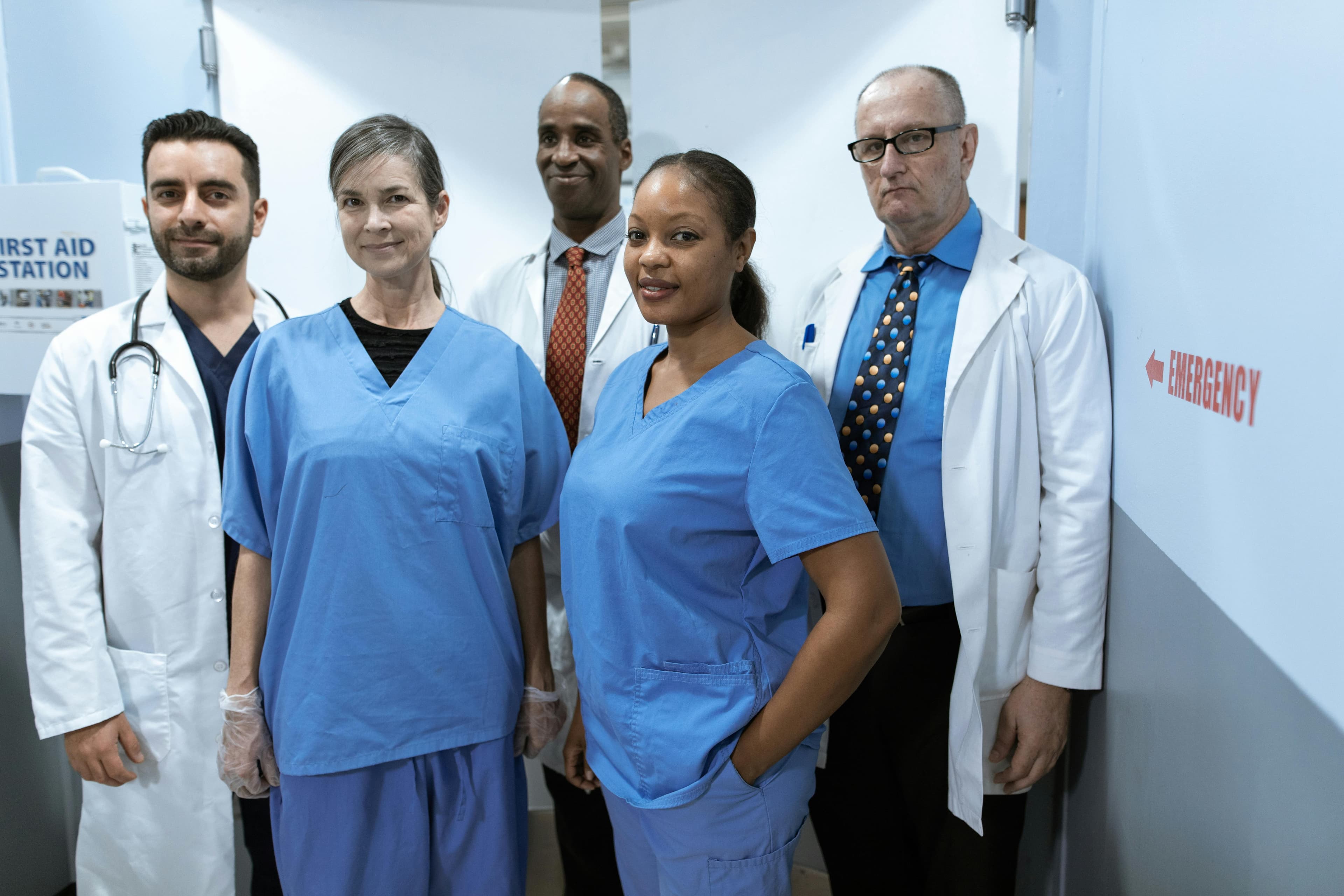 Diverse healthcare team assembled in a clinical setting.